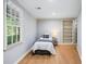 Bedroom featuring neutral paint, hardwood floors, and built-in shelving at 1506 Brookridge Dr, Woodstock, GA 30189