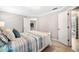 Bright bedroom with neutral carpet and walls featuring a bed and view of a bathroom through a doorway at 1506 Brookridge Dr, Woodstock, GA 30189