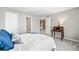 Bright bedroom with a bed, desk, and doorway views of the landing at 1506 Brookridge Dr, Woodstock, GA 30189