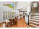 Charming dining area with lots of light, shuttered window and hardwood floors adjacent to staircase and flowing into an open kitchen at 1506 Brookridge Dr, Woodstock, GA 30189