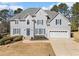 Stately two-story home featuring blue shutters, a manicured front yard, and a two-car garage at 1506 Brookridge Dr, Woodstock, GA 30189