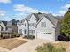 Beautiful two-story home with gray siding, manicured lawn, and a two-car garage at 1506 Brookridge Dr, Woodstock, GA 30189