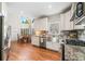 Open kitchen with stainless steel appliances, granite countertops, farm sink, and ample natural light, creating a chef-friendly space at 1506 Brookridge Dr, Woodstock, GA 30189