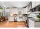 Bright kitchen with stainless steel appliances, granite countertops, farm sink, and open layout, perfect for cooking and entertaining at 1506 Brookridge Dr, Woodstock, GA 30189