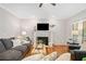 Cozy living room with a fireplace, hardwood floors, and ample seating at 1506 Brookridge Dr, Woodstock, GA 30189
