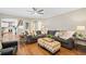 Inviting living room boasts hardwood floors, gray sofa, stylish ottoman and natural light, creating a warm and welcoming atmosphere at 1506 Brookridge Dr, Woodstock, GA 30189