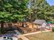 Community playground featuring play structures and benches amidst tall trees at 1506 Brookridge Dr, Woodstock, GA 30189