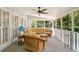 Relaxing screened porch featuring comfortable seating and view of surrounding trees and natural light at 1506 Brookridge Dr, Woodstock, GA 30189
