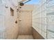 Walk-in shower with glass block window and neutral-toned tile surround at 1506 Brookridge Dr, Woodstock, GA 30189