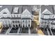 Aerial view of homes featuring inviting front porches and neatly manicured yards with picket fences at 646 Brashy St, Woodstock, GA 30188