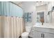 Bathroom featuring a shower, vanity, and light blue accents at 646 Brashy St, Woodstock, GA 30188