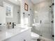 Bathroom featuring a glass-enclosed shower with marble, a quartz vanity and neutral finishes at 646 Brashy St, Woodstock, GA 30188
