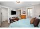 Relaxing bedroom with a desk, natural light, and comfortable blue bedding at 646 Brashy St, Woodstock, GA 30188