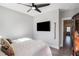 Spacious bedroom with a king-size bed and mounted television at 646 Brashy St, Woodstock, GA 30188