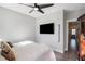 Bedroom showcasing a flat screen television, hardwood floors and comfortable bedding at 646 Brashy St, Woodstock, GA 30188