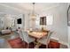 Dining room featuring wooden table with seating for six under a modern light fixture at 646 Brashy St, Woodstock, GA 30188