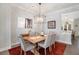 Bright dining room featuring wooden table with seating for six under a modern light fixture at 646 Brashy St, Woodstock, GA 30188
