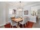 Open concept dining room with a view into the kitchen and features a wood table and chandelier at 646 Brashy St, Woodstock, GA 30188