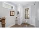 Bright entryway with hardwood floors, white door, and art at 646 Brashy St, Woodstock, GA 30188
