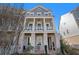 Attractive three-story home featuring a columned porch and well-maintained yard at 646 Brashy St, Woodstock, GA 30188
