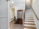 Elegant foyer with a staircase, hall tree, and neutral color palette at 646 Brashy St, Woodstock, GA 30188