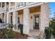 Front porch with brick columns, stone flooring, and seating at 646 Brashy St, Woodstock, GA 30188