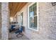 Cozy front porch featuring brickwork, outdoor seating, and natural light at 646 Brashy St, Woodstock, GA 30188