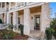 Inviting front porch with exposed beam ceiling and charming brick columns at 646 Brashy St, Woodstock, GA 30188