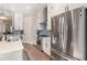 Modern kitchen featuring white cabinets, stainless steel appliances, and an island at 646 Brashy St, Woodstock, GA 30188
