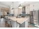 Modern kitchen featuring white cabinets, stainless steel appliances, and a gray island with seating at 646 Brashy St, Woodstock, GA 30188