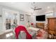 Cozy living room featuring a reclining sofa, hardwood floors, ceiling fan, and access to the outside at 646 Brashy St, Woodstock, GA 30188