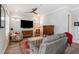 Comfortable living room featuring a reclining sofa, hardwood floors, and a ceiling fan at 646 Brashy St, Woodstock, GA 30188