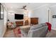 Cozy living room with hardwood floors, comfortable seating, and a ceiling fan at 646 Brashy St, Woodstock, GA 30188