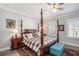 Main bedroom featuring a large four-poster bed and hardwood floors at 646 Brashy St, Woodstock, GA 30188