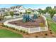 Community playground with slides and climbing structures, surrounded by a white picket fence at 646 Brashy St, Woodstock, GA 30188
