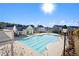 A community pool surrounded by residences, complete with lounge chairs and a tranquil atmosphere on a bright day at 646 Brashy St, Woodstock, GA 30188