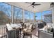 Relaxing screened porch featuring comfortable seating, a bar area, and outdoor cooking equipment at 646 Brashy St, Woodstock, GA 30188