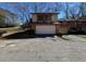 Two-story townhome with a two-car garage and balcony overlooking a grassy yard at 1153 Village Main St, Stone Mountain, GA 30088