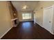 Inviting living room with wood floors, brick fireplace, and a modern ceiling fan at 1153 Village Main St, Stone Mountain, GA 30088