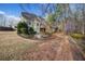 View of home's backyard featuring mature trees and landscaping plus a two-level back deck at 2007 Woodside Park Dr, Woodstock, GA 30188
