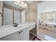Bathroom featuring single sink with vanity, mirror, and view into a bedroom at 2007 Woodside Park Dr, Woodstock, GA 30188