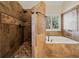 Luxurious bathroom with tiled shower, separate soaking tub and garden window at 2007 Woodside Park Dr, Woodstock, GA 30188