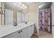 Bathroom with a double sink vanity, large mirror, and a separate shower area at 2007 Woodside Park Dr, Woodstock, GA 30188