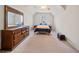 Spacious bedroom featuring carpet, ceiling fan, window, and a large dresser with a mirror at 2007 Woodside Park Dr, Woodstock, GA 30188