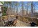 Upper deck with outdoor table and chairs, offering a peaceful view of the surrounding trees at 2007 Woodside Park Dr, Woodstock, GA 30188