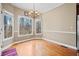 Bright dining area with wood floors and large windows offering a picturesque view at 2007 Woodside Park Dr, Woodstock, GA 30188