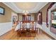 Elegant dining room boasts hardwood floors, a chandelier, and ample natural light at 2007 Woodside Park Dr, Woodstock, GA 30188