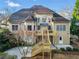 Rear exterior of home with large windows, multi-level deck and stairs leading to the yard at 2007 Woodside Park Dr, Woodstock, GA 30188