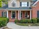 Charming home showcasing a welcoming front porch with classic columns and well-maintained landscaping at 2007 Woodside Park Dr, Woodstock, GA 30188