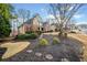 Inviting two-story home with a well-manicured lawn, mature trees, and a side-entry garage at 2007 Woodside Park Dr, Woodstock, GA 30188